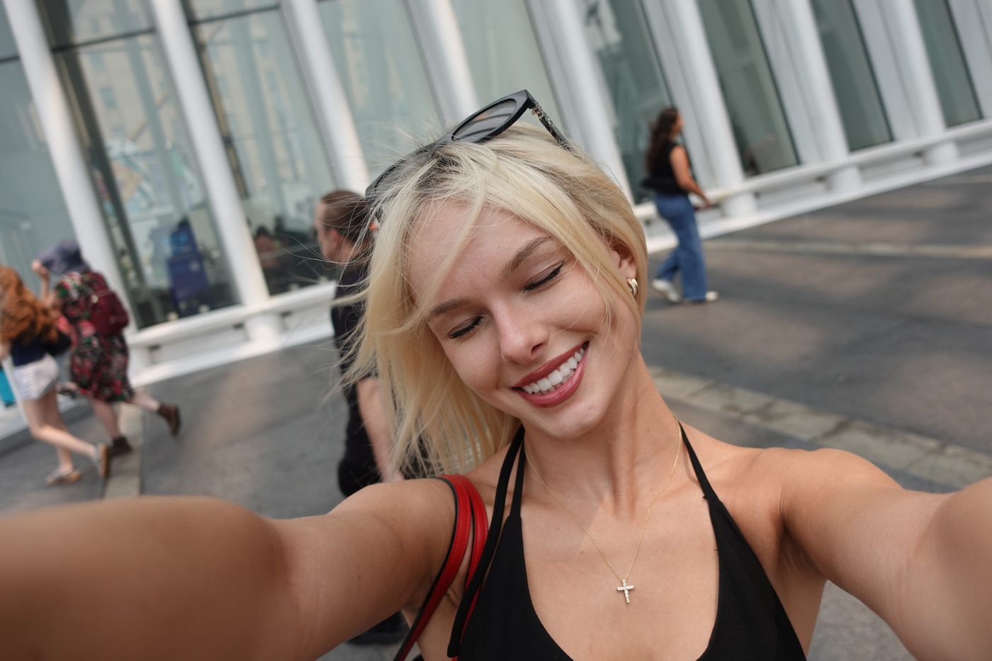 Madeline smiling in a selfie on a city street