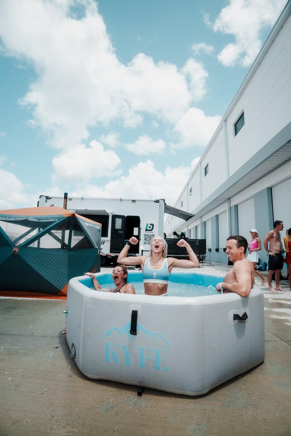 Madeline flexing in an ice bath at an outdoor fitness event